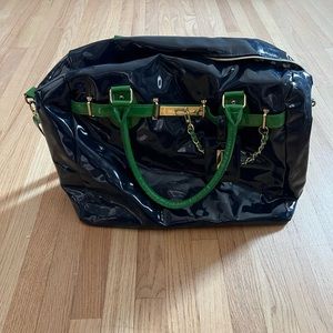 Navy patent Steve Madden overnight bag with kelly green trim and gold accents